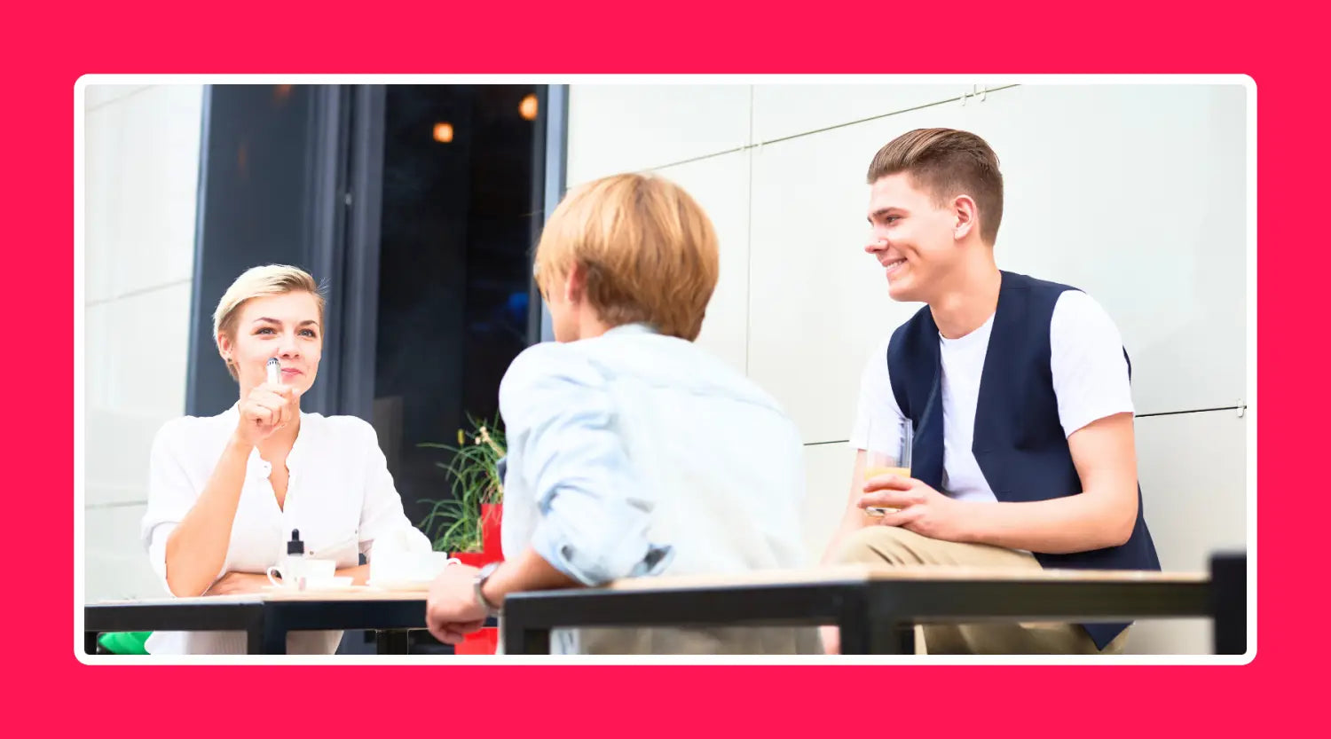 Three individuals engaged in conversation at a table. Join Smokz Vape Store Vaping community for successful switch.